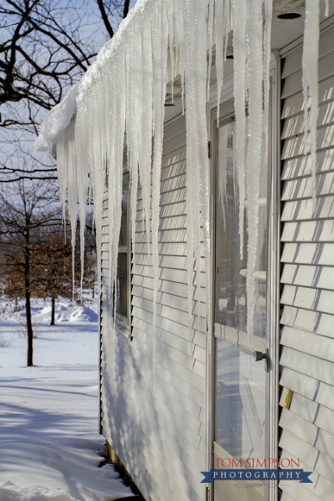 icicles hang from snow covered roof in old nauvoo