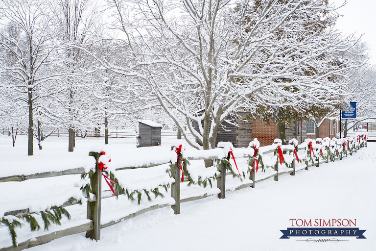 snow evergreen swags pinecones split rail fence tom simpson photography